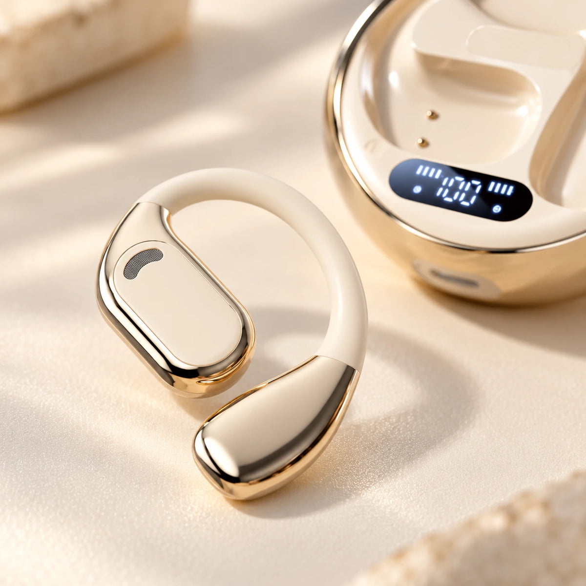 Close-up of the flexible ivory M76 ear hook and polished gold trim