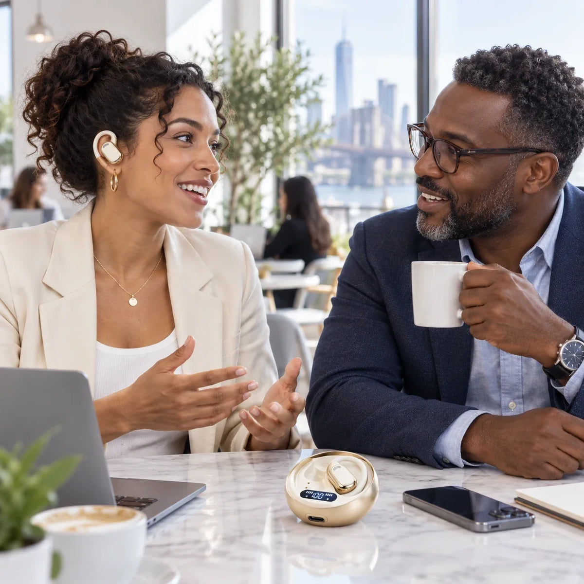 Woman using ivory M76 earbuds during a coworking conversation
