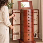 Illustrative AI scene: choosing a necklace from the side hooks; jewelry and decor not included
