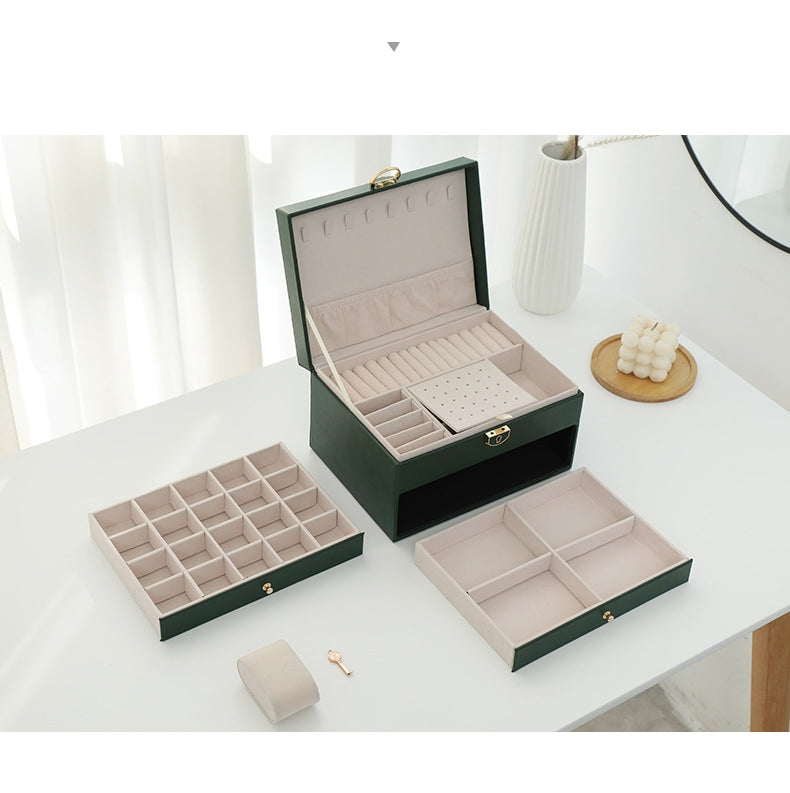 Green jewelry organizer with two pull-out drawers removed, beige watch cushion and included key