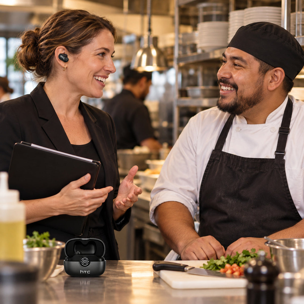 Restaurant coworkers using black translator earbuds for a practical conversation